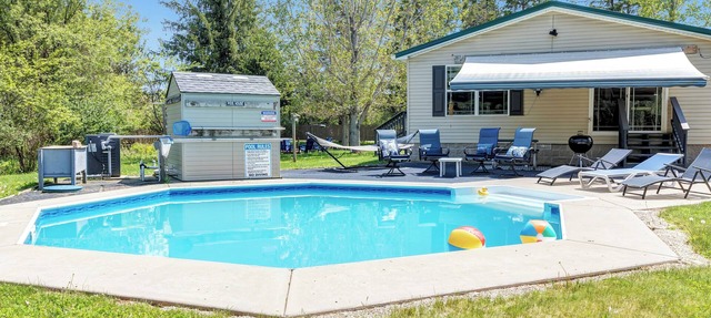 Brand new listing! Relax and unwind at this stunning Northwoods pool house featuring a private in-ground pool, fire pit, patio, garage space, and sleeping for 11 guests! in Mountain