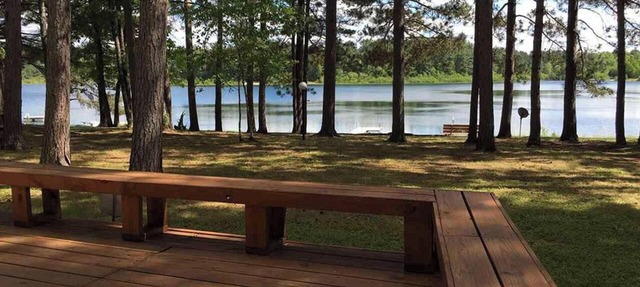 Northwoods lake home with gentle slope to clear lake with sandy beach in Barnes