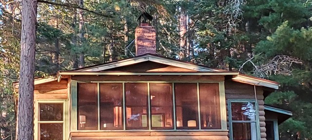 Rustic cabin in remote wooded area on point overlooking lake. in Bigfork